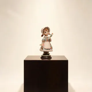 Hummel porcelain figurine on a collector shelf